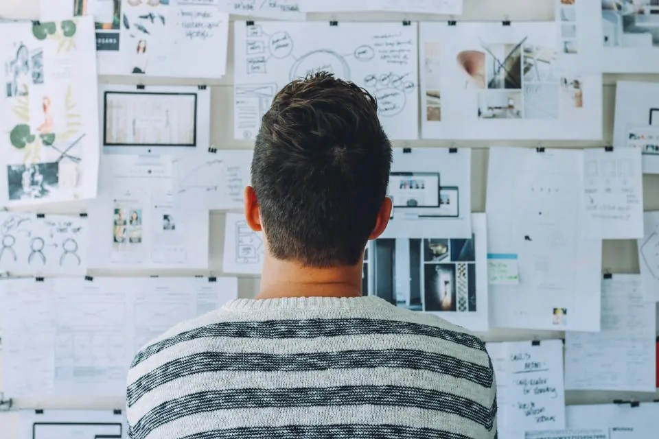A student mapping a venture across the studio wall
